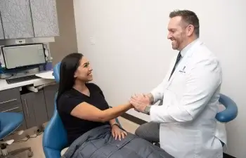 Client shaking dentist hand